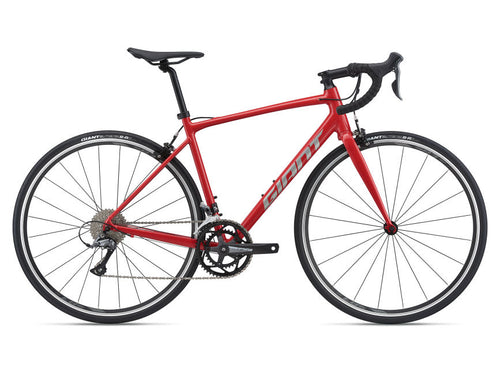 A red Giant bicycle with a steel frame and components, including a rear derailleur, stem, and seatpost.