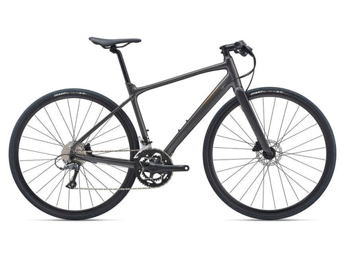 A metallic black Giant road bicycle with a flat handlebar, overdrive steerer, and a Giant Sport saddle.