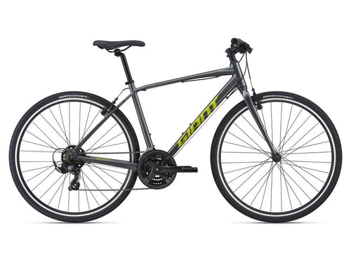 A charcoal-colored bicycle with a Giant brand frame, featuring a front derailleur, rear derailleur, and a chain drive.