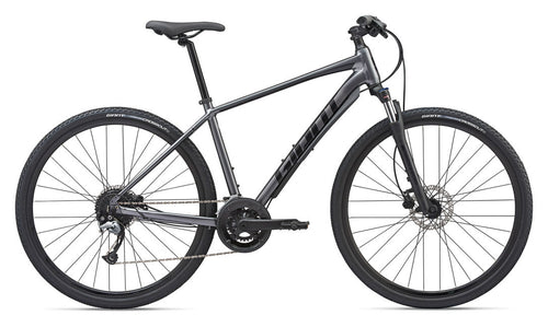 A charcoal-colored Giant bicycle with a road bike frame, disc brakes, and a Shimano shifter.