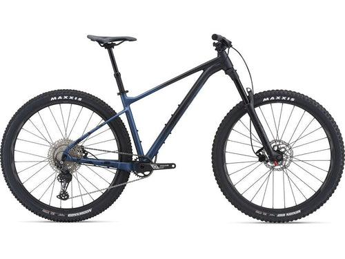 A black and blue Giant FATHOM 29er mountain bike with a rear-wheel view, showing the frame, fork, and tires.