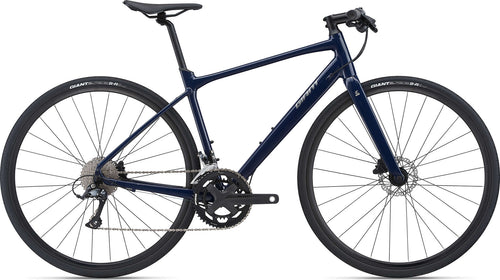 A navy blue Giant Fastroad SL 2 - Eclipse road bicycle with a flat handlebar, disc brakes, and alloy wheels.