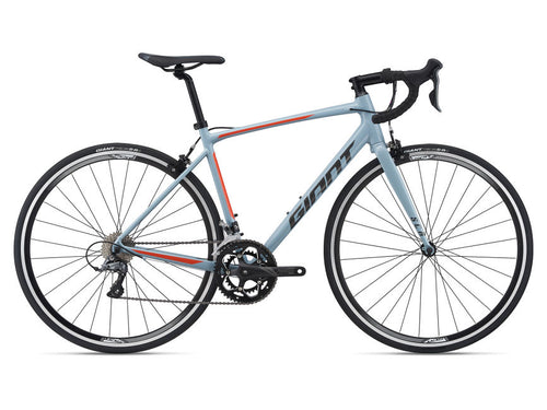 A dusty blue Giant road bicycle with ALUXX-grade aluminum frame, alloy drop handlebar, and Shimano Claris components.